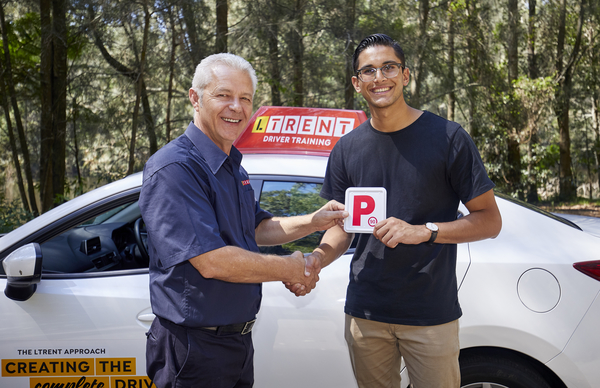 ltrent instructor and student holding red p plate