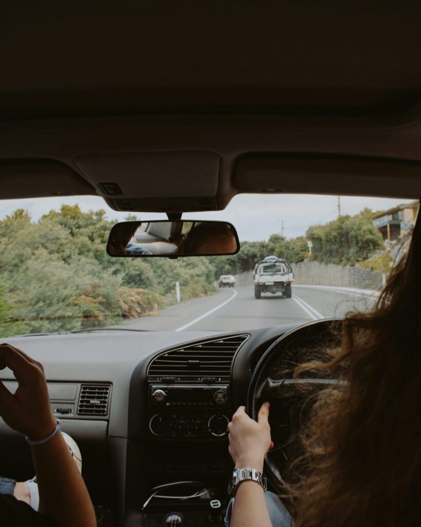 Adult learner driver with a passenger in the car during real-world driving practice