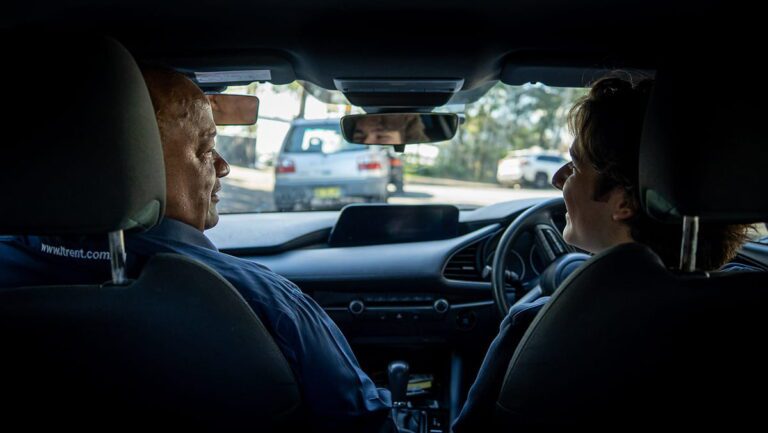 An adult learner driver practising on NSW roads with an LTrent driving instructor during a confidence-building driving lesson.
