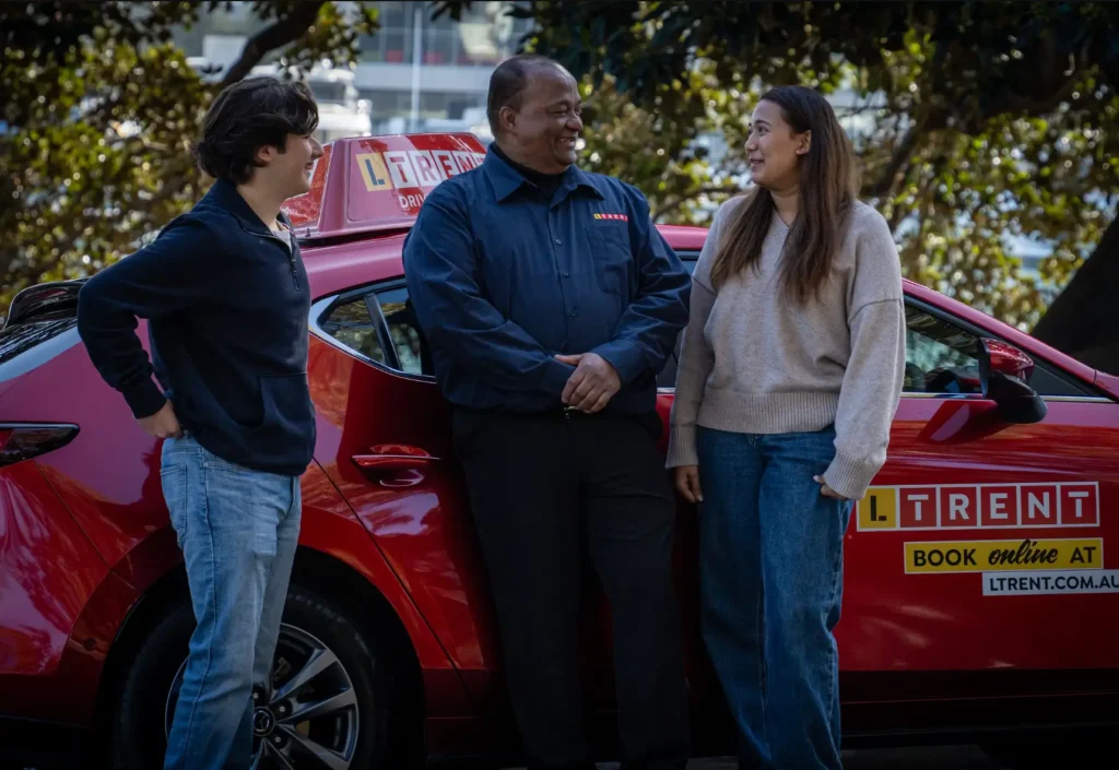 LTrent driving instructor with learner drivers after a driving lesson, celebrating progress and building confidence.