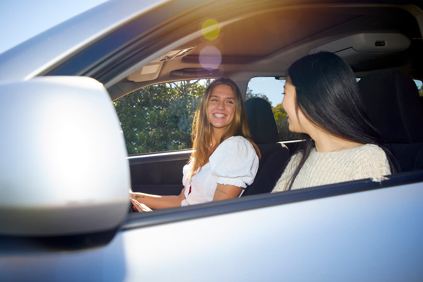 Learner driver building confidence through calm, supportive driving practice with a supervising passenger.