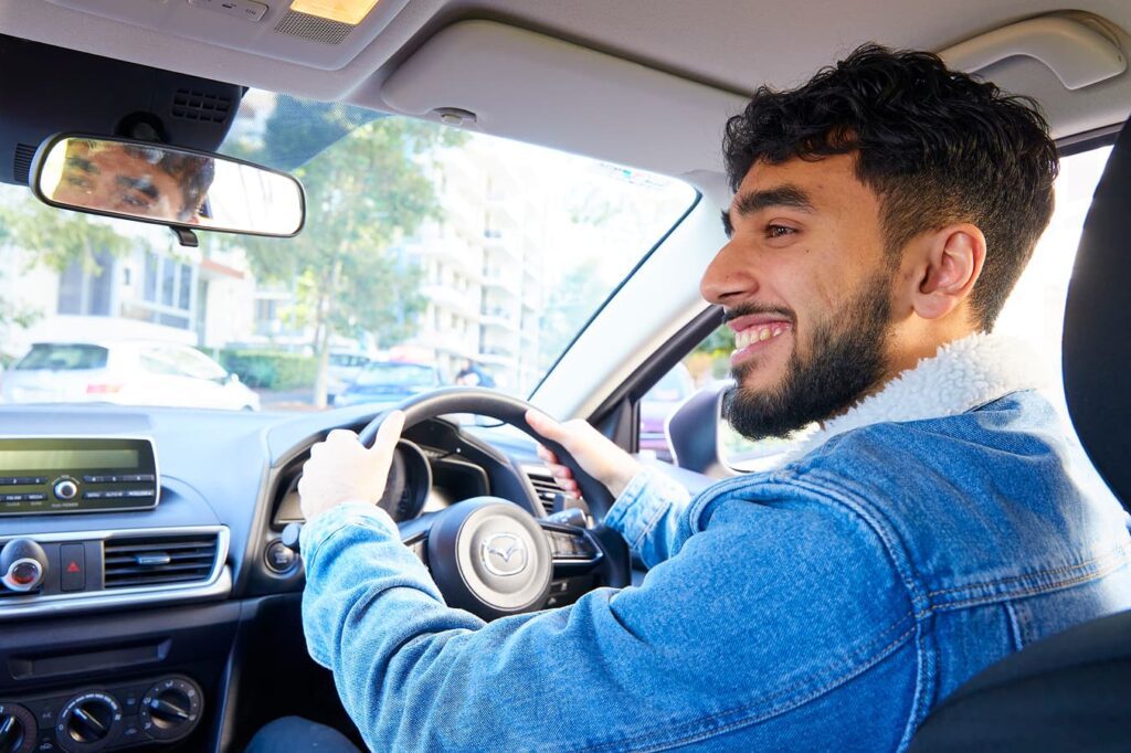 Learner driver building confidence behind the wheel during a supervised driving lesson.