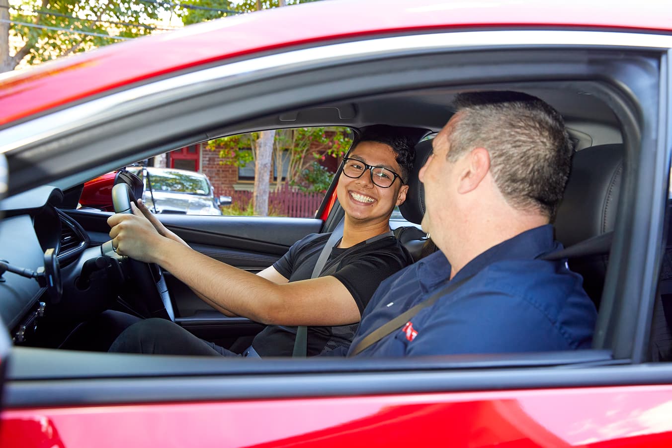 Learner driver gaining confidence with calm guidance from a professional driving instructor.