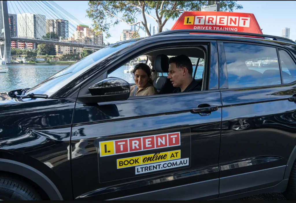Learner driver listening to a driving instructor before beginning a practical driving lesson.