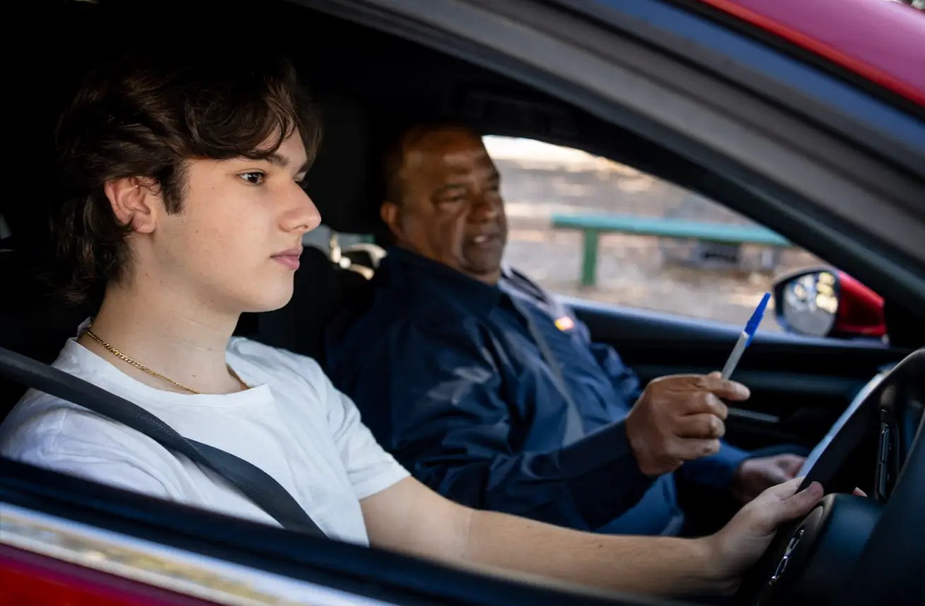 Learner driver practising with a driving instructor on NSW roads while building confidence behind the wheel.