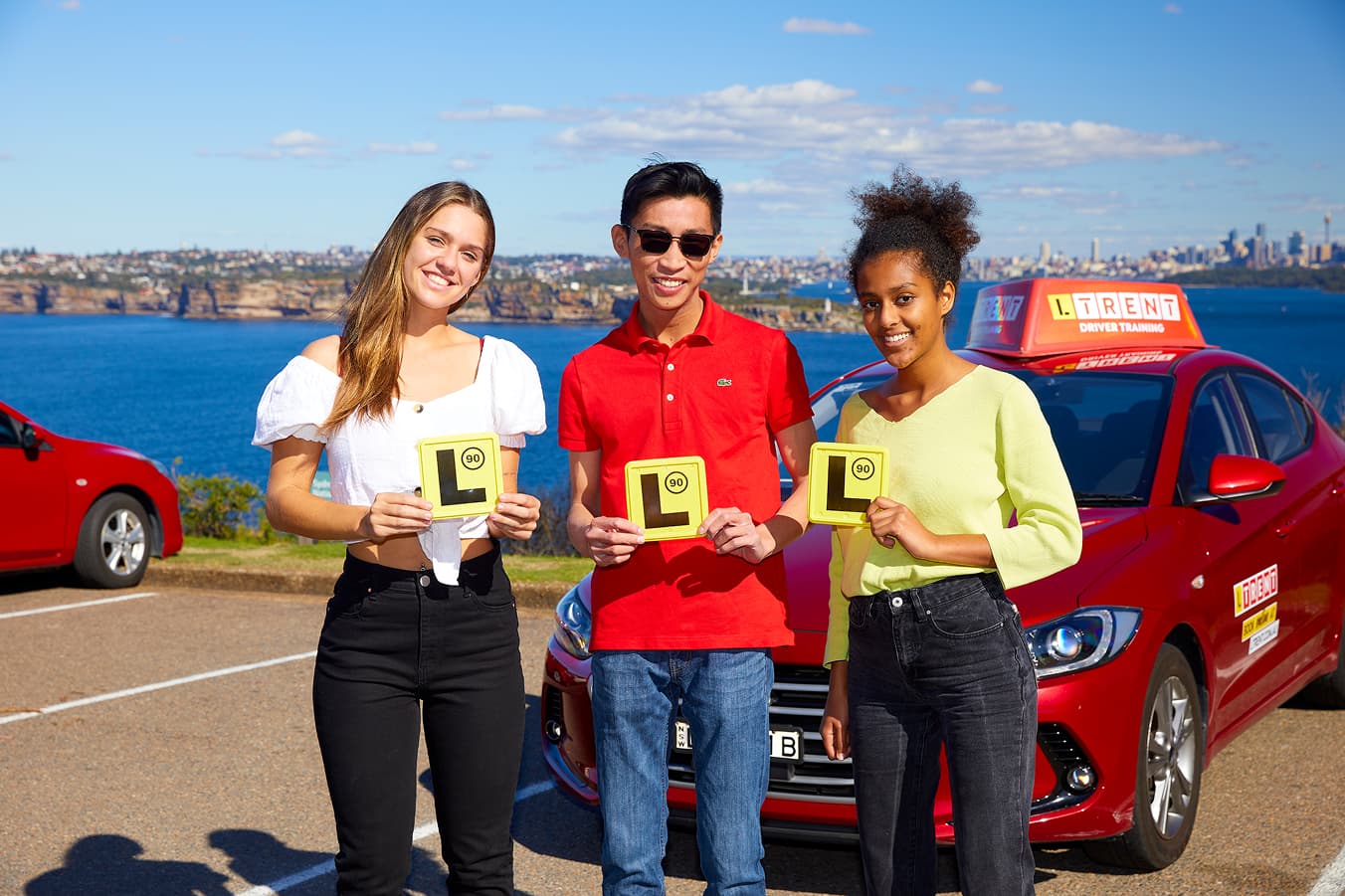 New drivers celebrating after successfully passing their driving test with LTrent Driver Training.