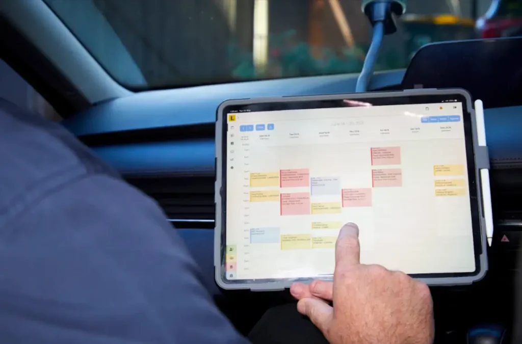 Driving instructor planning learner driving lessons using a digital schedule.