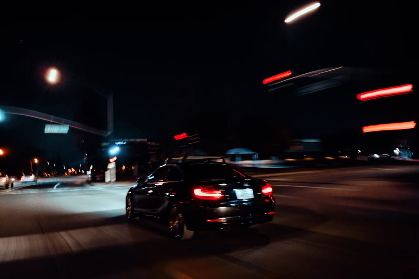 Car driving on a city road at night